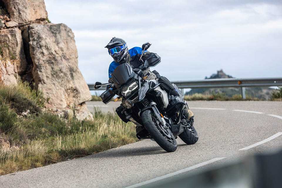 BMW R1250 GS fully equipped with Wunderlich Parts & Accessories with a rider standing next to the bike.